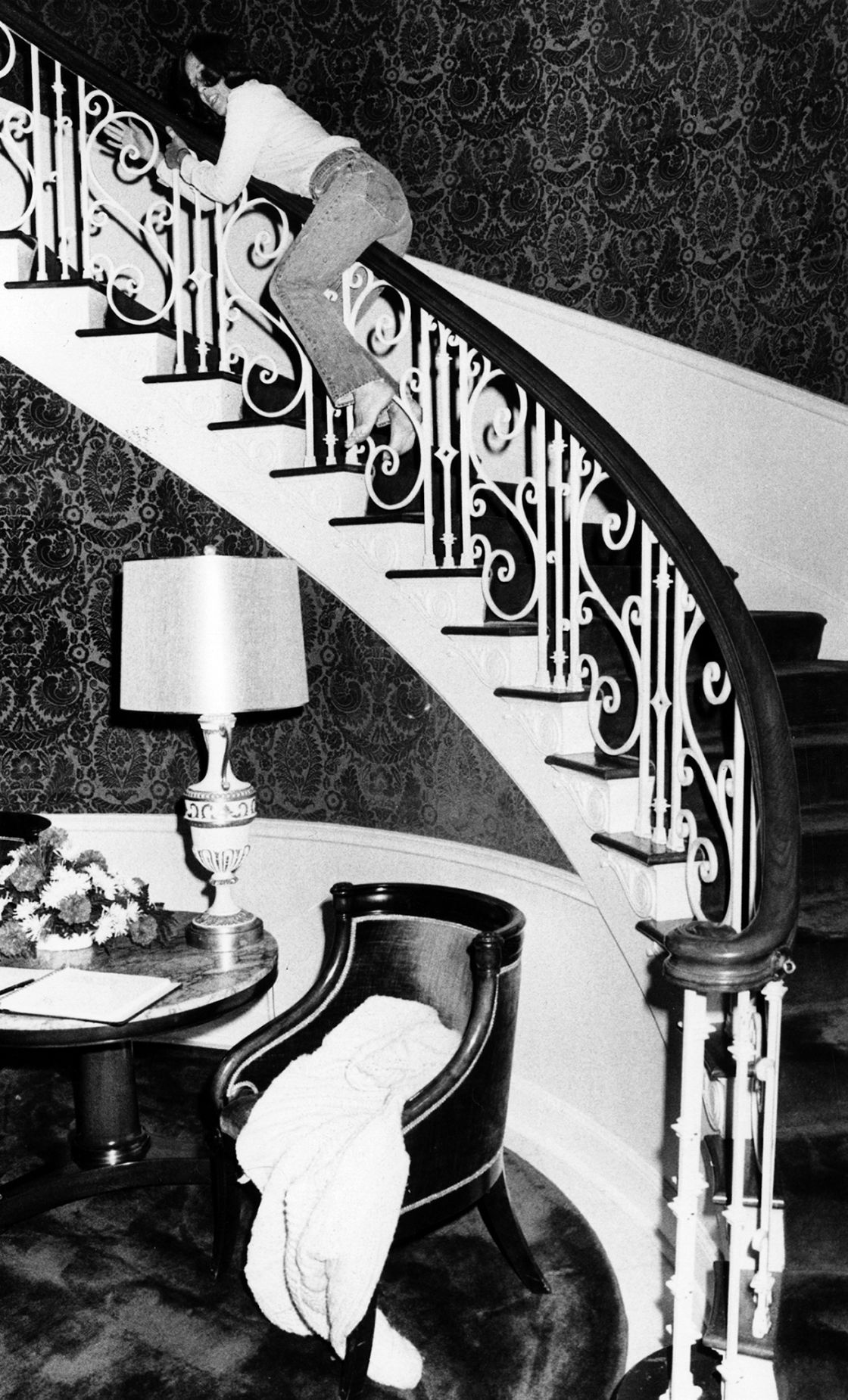 Ruth Thone, sliding down banister